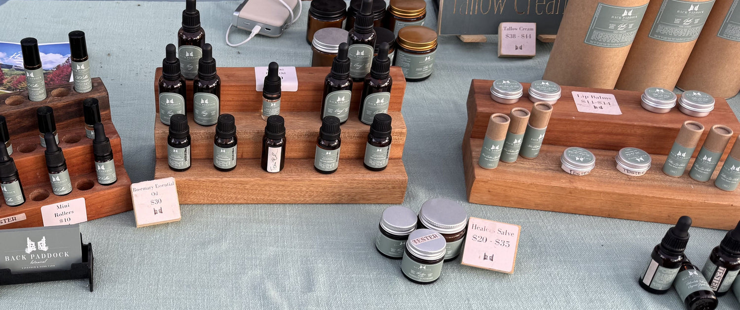 Display of small bottles and containers on a table with price tags.