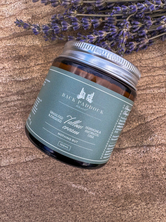 Jar of Back Paddock Botanical Tallow Cream on a wood board with lavender