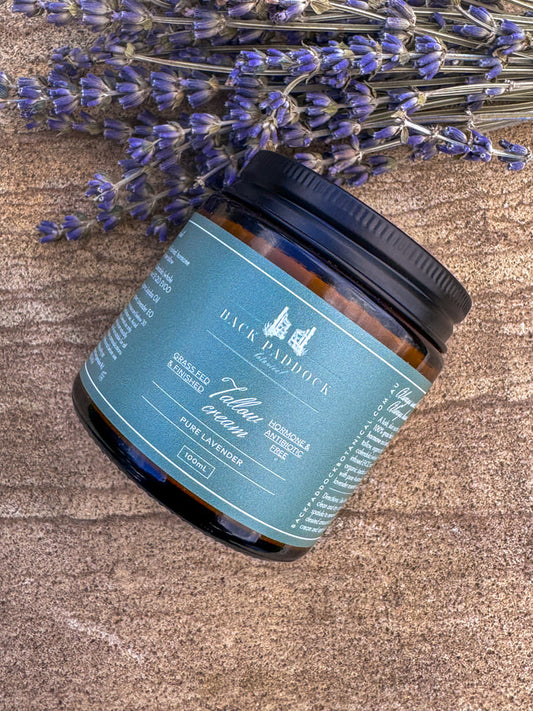 Back Paddock branded pure lavender tallow cream jar on a wood board with lavender.