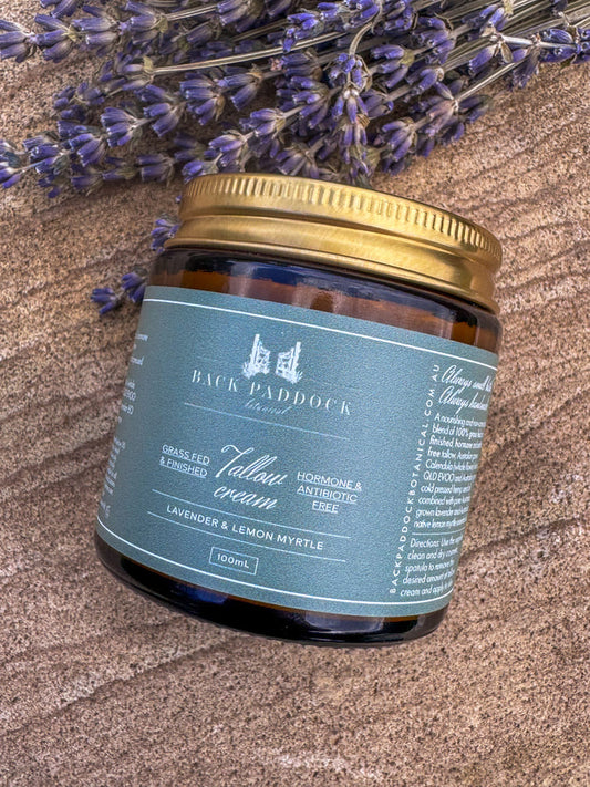 Jar of Back Paddock lemon myrtle Tallow cream with lavender flowers on a textured surface